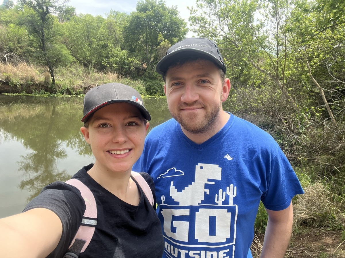 Michane and Ross hiking by a river